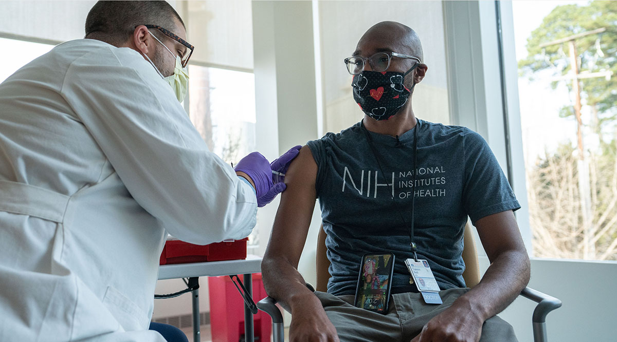 Taison Bell, MD, gets one of the first Pfizer coronavirus vaccinations at UVA Health on Dec. 15.