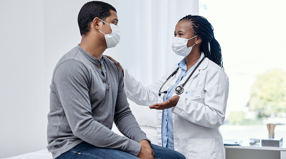 A diverse doctor and patient talk in an exam room