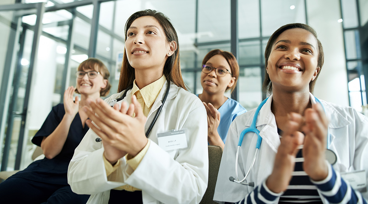 A group of doctors and medical professionals discussing a topic in a meeting