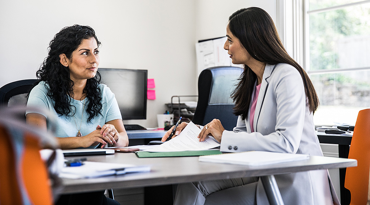 A group of doctors and medical professionals discussing a topic in a meeting