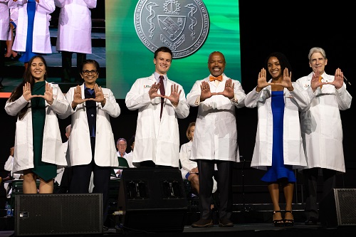 students and faculty posing during white coat ceremony