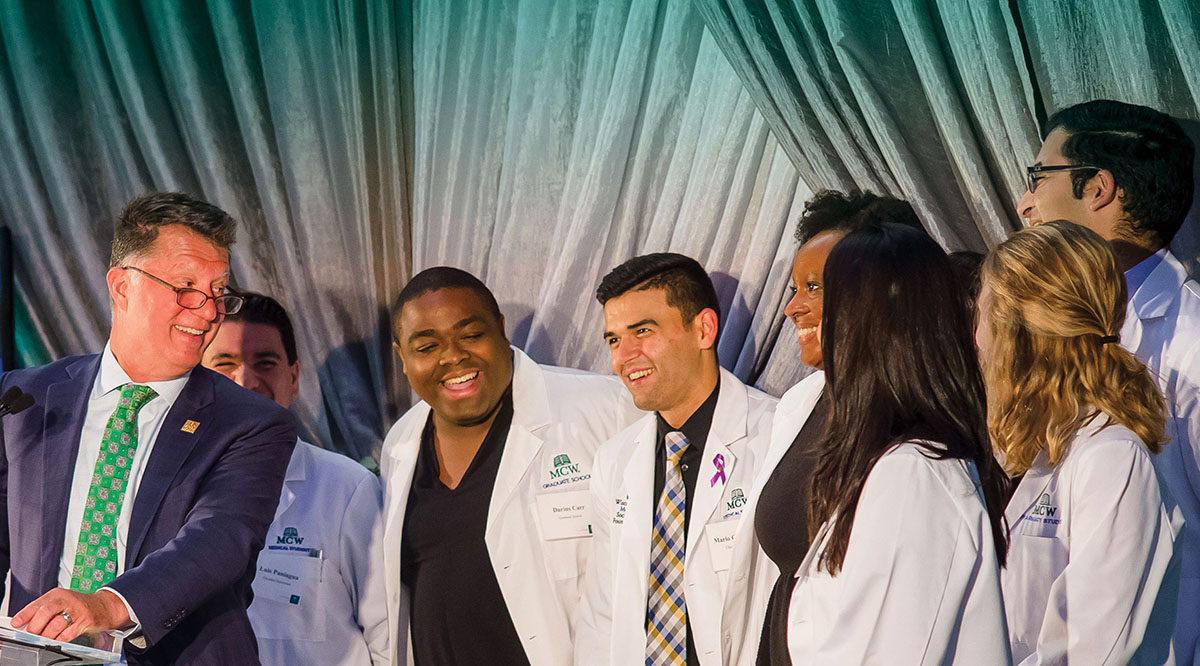 Joseph Kerschner, MD, dean of the school of medicine at the Medical College of Wisconsin, shares a laugh with students during the school’s 125th anniversary celebration in September 2018