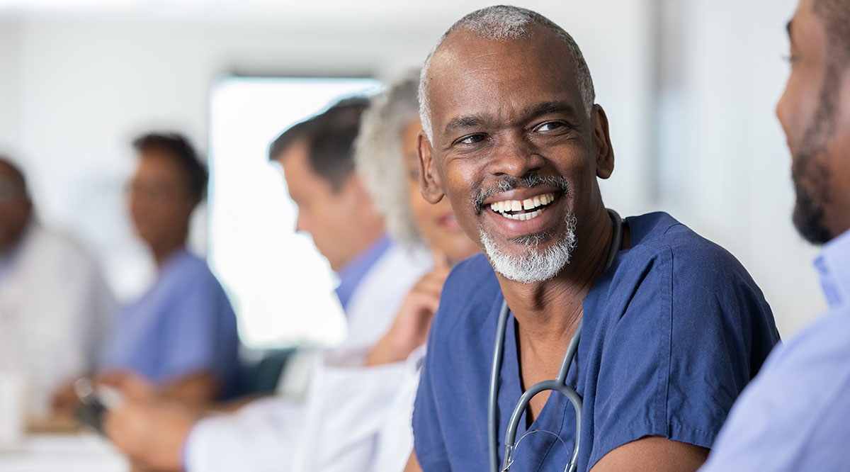 An older medical student smiles