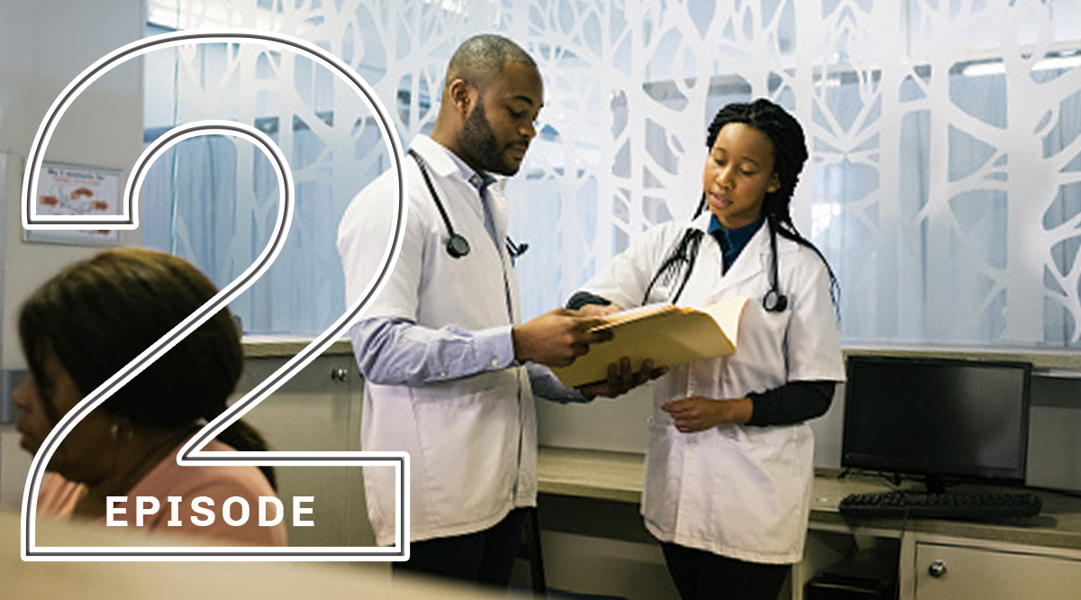 Young African doctors discussing files in clinic reception