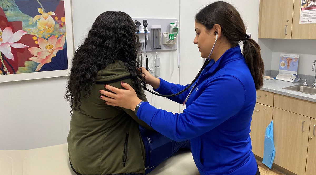 Salomeh "Sally" Salari, MD, an OB-GYN resident at University Hospitals Cleveland Medical Center, examines a patient during a recent shift