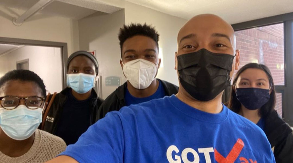 Alister Martin, MD, MPP, poses for a group photo with GOTVax volunteers as they work to bring vaccines to under-resourced neighborhoods in Boston.