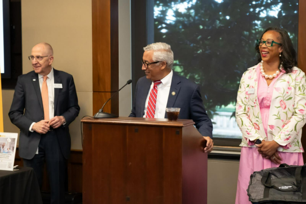 AAMC leadership stands behind a podium