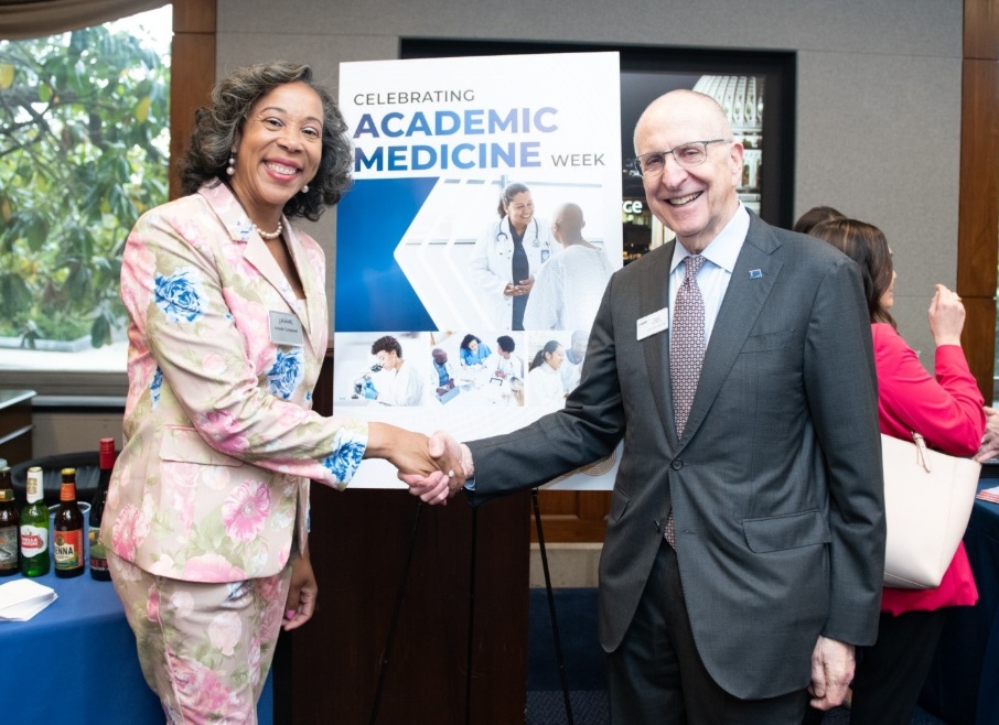 AAMC Chief Public Policy Officer, Danielle Turnipseed and AAMC President and Chief Executive Officer, David Skorton pose for the camera while shaking hands