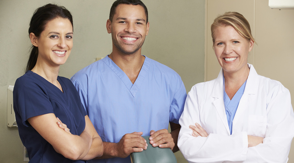 StandPoint Surveys Health Professionals Three health professionals look toward the camera and smile.