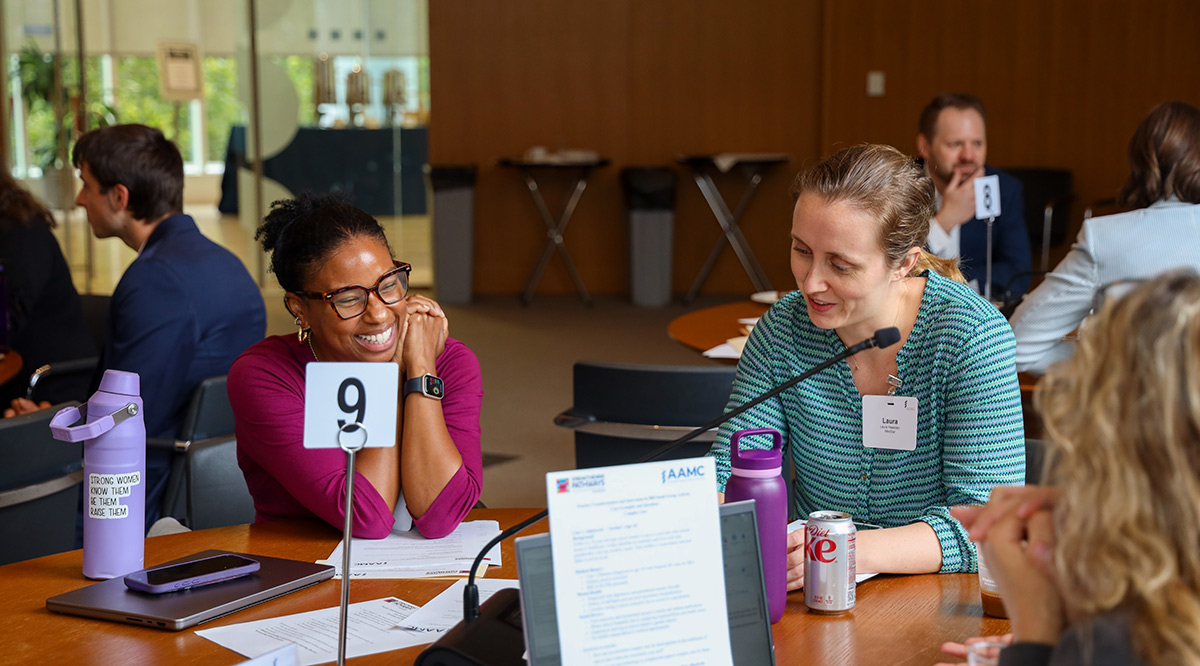 People having a discussion at the 2025 AAMC symposium on IBH