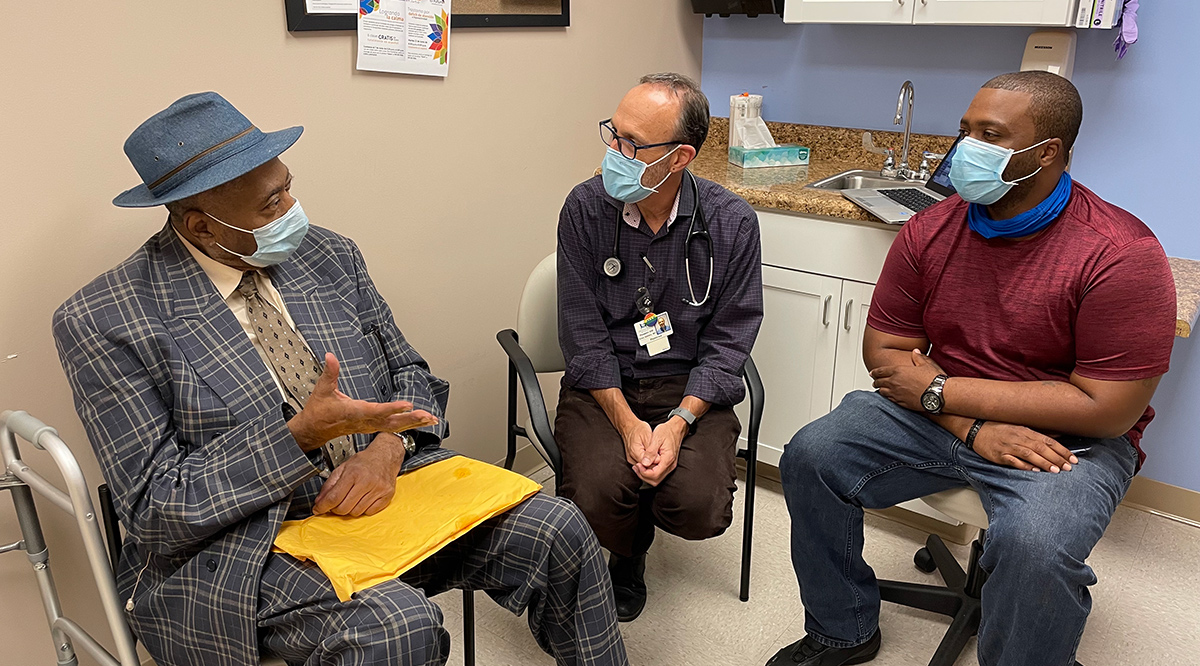 Evan Ashkin, MD, and community health worker Tommy Green (right), work with a patient in the Formerly Incarcerated Transition Clinic in Chapel Hill, North Carolina. (The patient granted permission to use his image but asked that his name be withheld.)