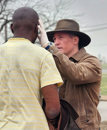 Nathanial Nolan, MD, founder of Street Med STL, examines a patient.