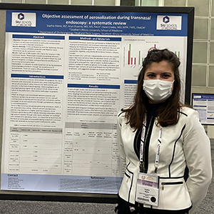 Sophia Matos, MD, poses with a poster she presented during her research year.