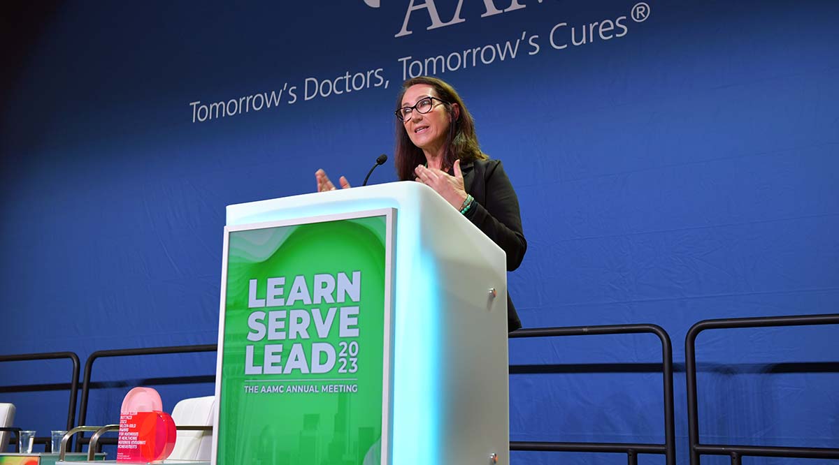 Maria Elena Bottazzi, PhD, speaks at a podium during Learn Serve Lead 2023.