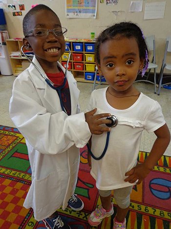 Photo courtesy of Bridging the Gaps two kids acting as a doctor and a patient