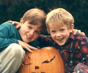 Dean (left) and Kevin Powers celebrating Halloween, 1988. Credit: Courtesy of Ron Powers. Two children posing with Halloween pumpkin