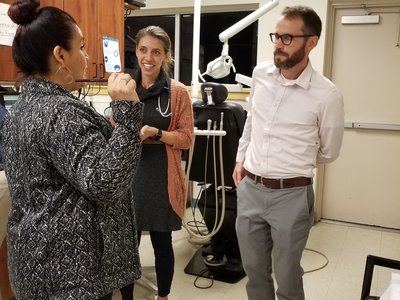 CHW Lidia Regino talks with resident Sarah Friedberg, MD, and attending physician David Armstrong, MD, at the One Hope clinic. Credit: Virginia Sandoval CHW Lidia Regino talks with resident Sarah Friedberg, MD, and attending physician David Armstrong, MD, at the One Hope clinic.