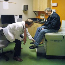 A student performs an exam on a standardized patient.