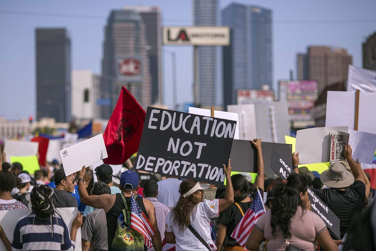 Thousands of immigrants and supporters marched to oppose the order to end DACA on September 10, 2017, in Los Angeles, Calif. (Photo by David McNew/Getty Images) Protesters holding signs