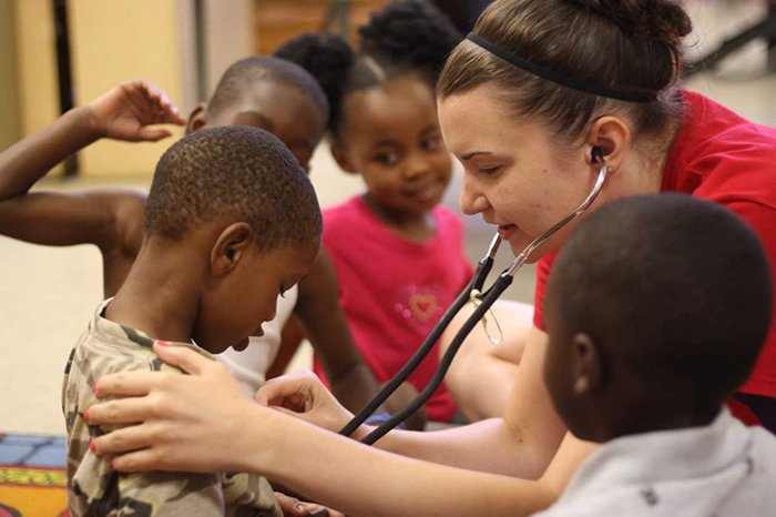 a woman examining a boy