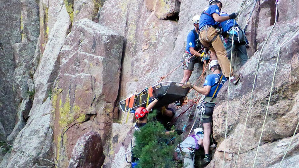 Alison Sheets, MD, medical director of the Rocky Mountain Rescue Group, oversees the rescue of a climber who fell while hiking a sheer rock wall in Eldorado Canyon.