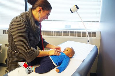 Olga Valdman, MD, treats a child at the refugee health clinic at the Family Health Center of Worcester in Massachusetts.