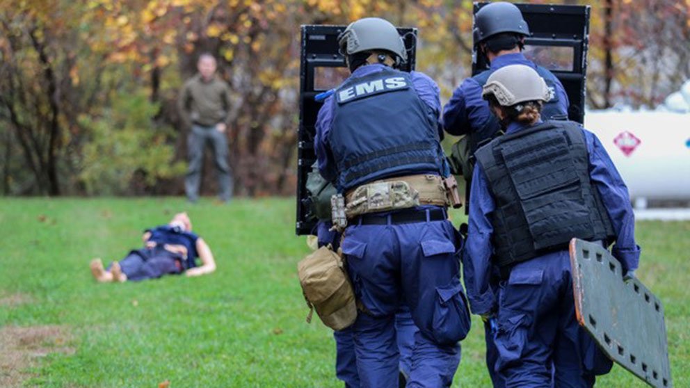 A physician and tactical team members practice rescue maneuvers using a simulated patient at a training conducted by the Johns Hopkins Center for Law Enforcement Medicine.