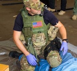 Keith Murray, MD, trains SWAT team members how to apply pressure to stop bleeding.