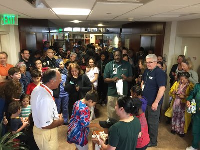Eduardo C. Alfonso, MD, (at left in white shirt), director of Bascom Palmer Eye Institute, and other leaders join families in celebrating three children’s birthdays during the storm. Credit: University of Miami Miller School of Medicine. Eduardo C. Alfonso and other leaders join families in celebrating three children’s birthdays during the storm.