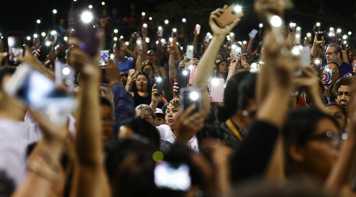 crowd at night holding up their cellphones