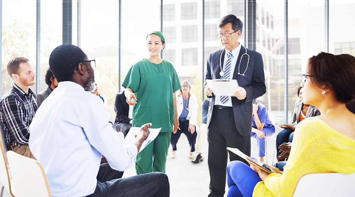 Diverse people listening to the doctor’s presentation