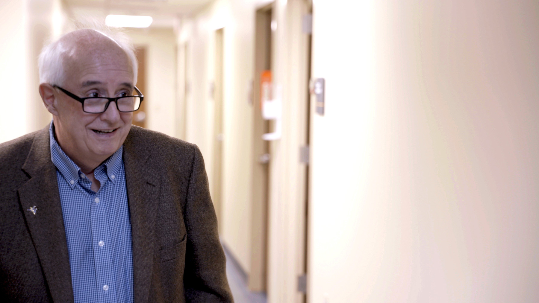 Dr. John Brick stands in the hallway of the WVU clinic