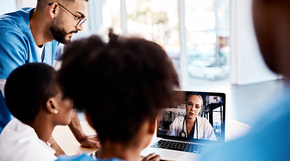 A group of young doctors having a video conference with a laptop in a hospital