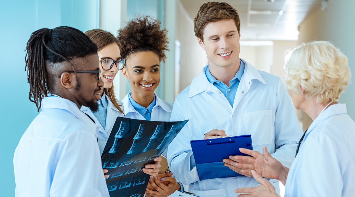 Medical residents talking to a doctor