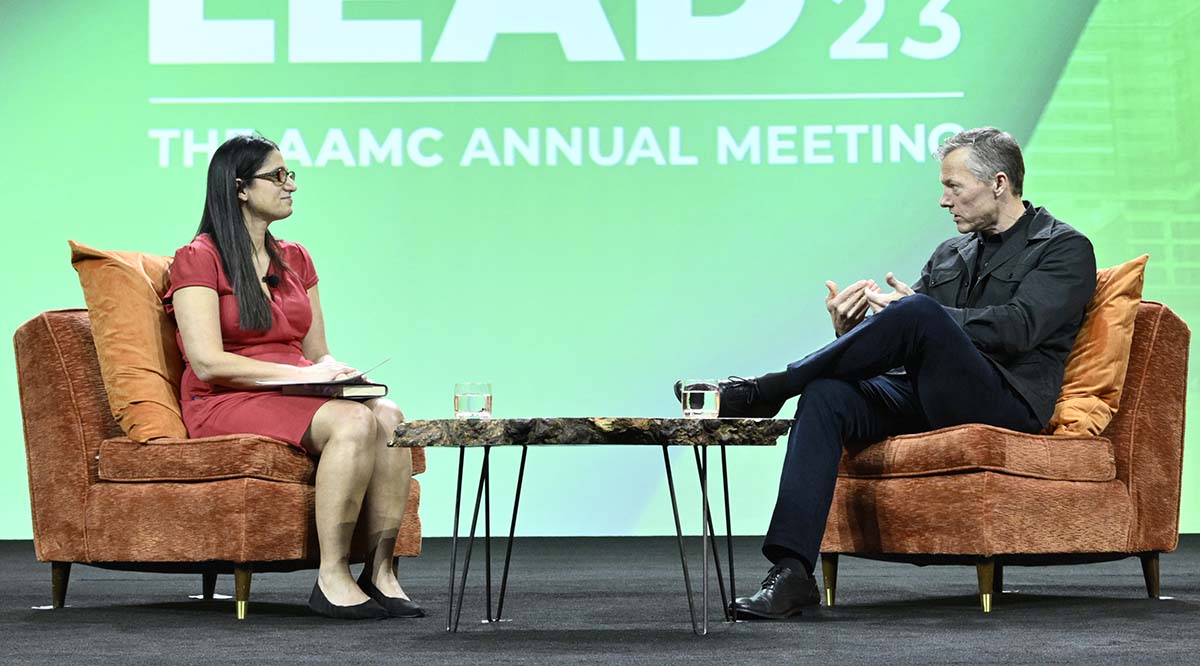Matthew Desmond, PhD, speaks on stage with a guest during Learn Serve Lead 2023.