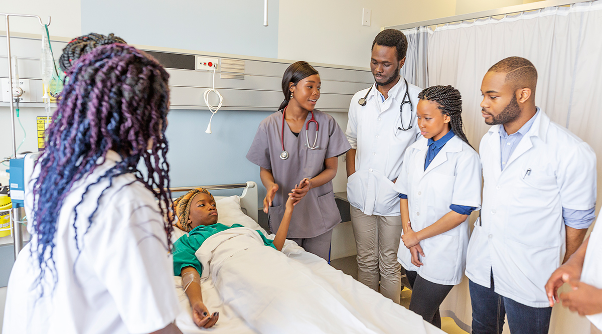 Group of medical students with a hospital patient