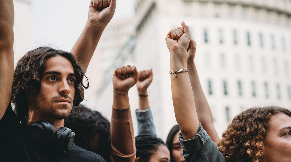 People with raised fists at a demonstration in the city