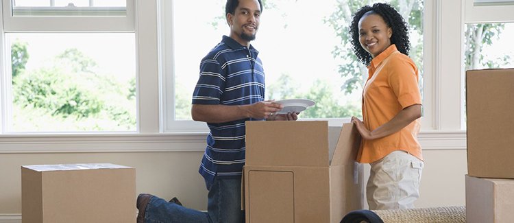 Couple unpacking new home Couple unpacking new home