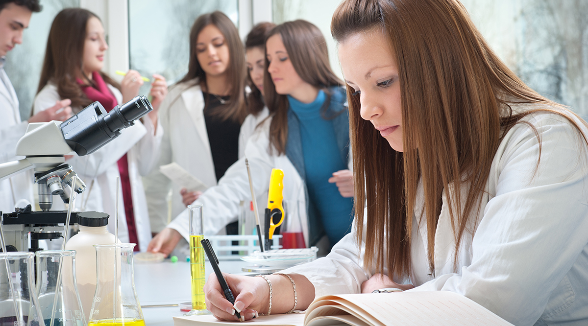 Medical student writing in the laboratory Medical student writing in the laboratory