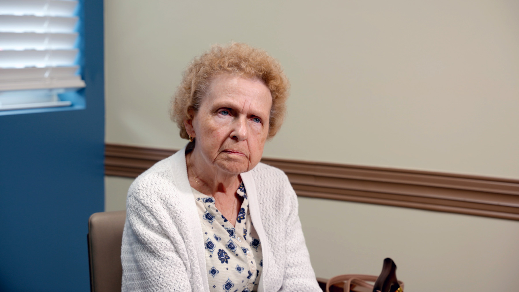 Stella Miles sits in a patient room