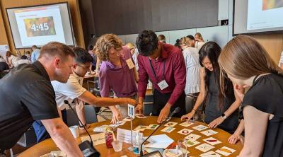 A group of participants collaborate on an activity at a table.