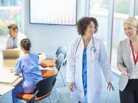 Doctors, nurses, and administrative staff meeting in a conference room