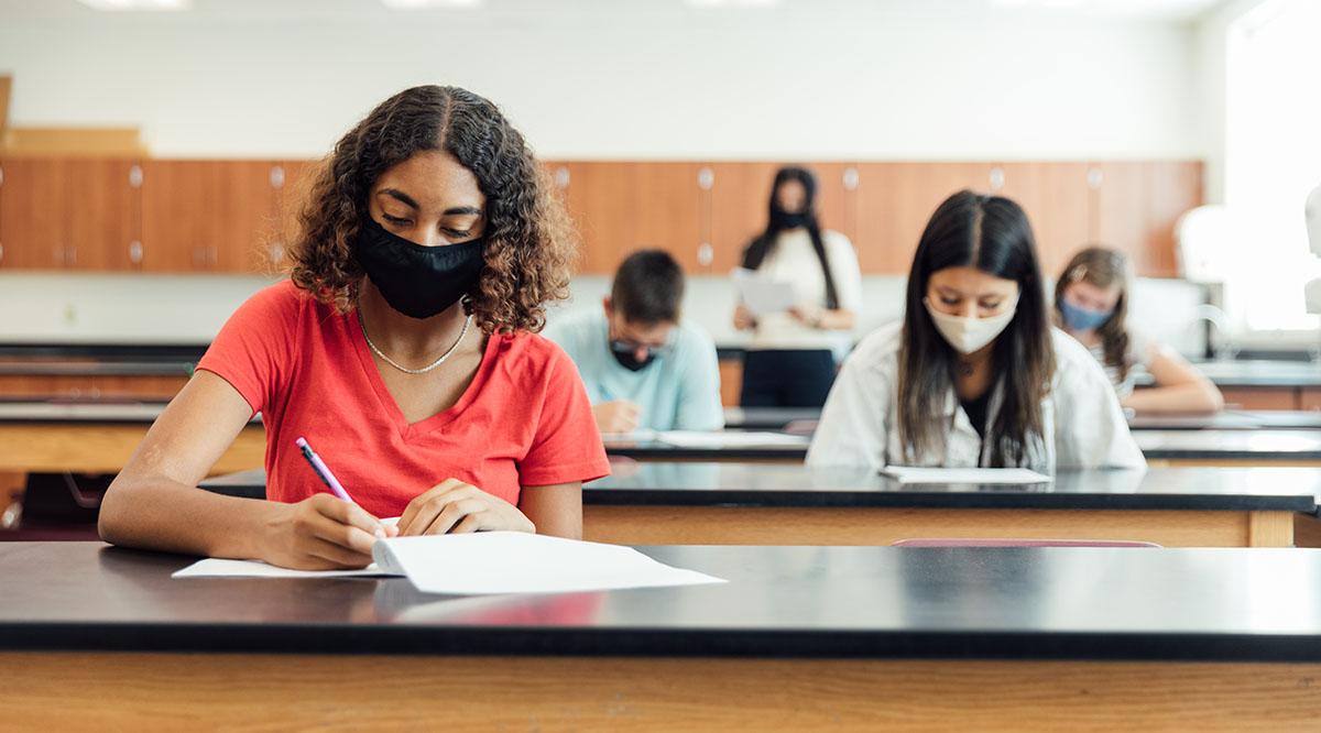 Students study in classroom with masks