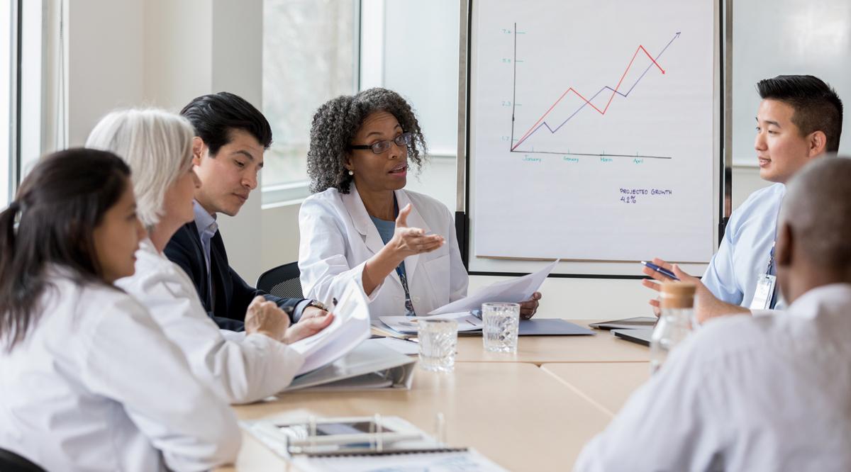 A group of doctors and medical professionals listening to a presentation.