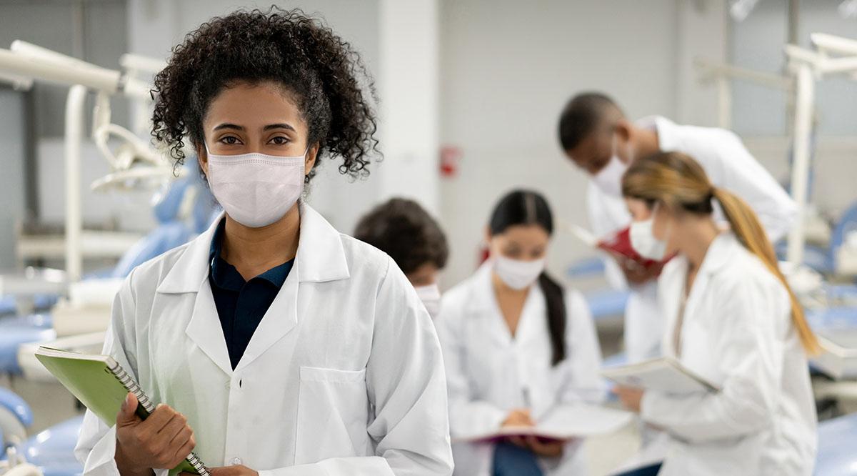 Female student back at school and wearing a facemask during the pandemic