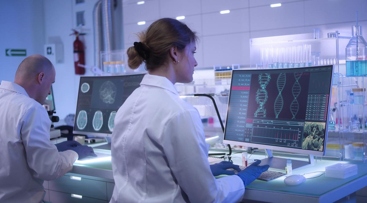 Scientists examines DNA models in modern neurological research laboratory.