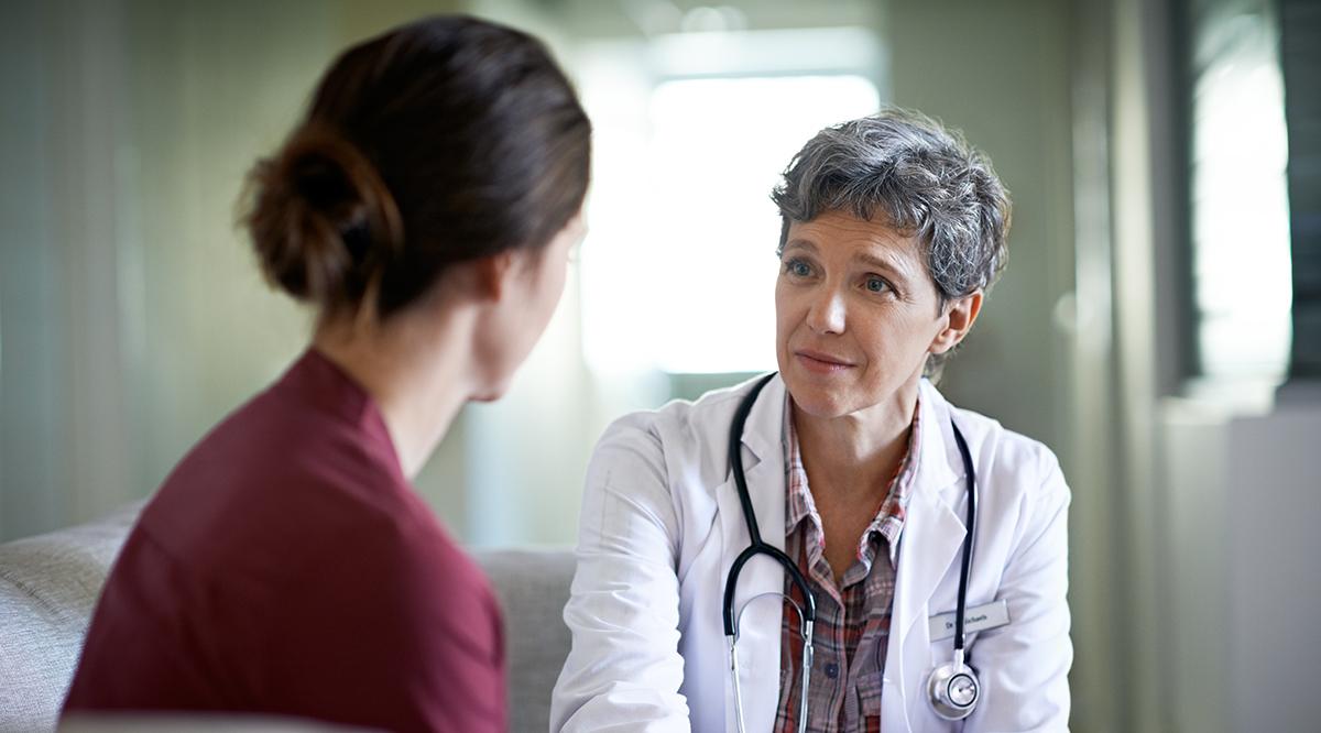 Shot of a compassionate doctor comforting a young woman in a hospital waiting room