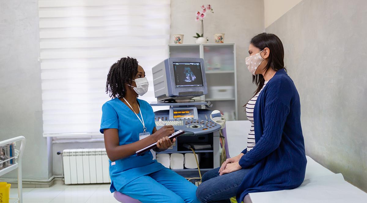 African-American female doctor doing gynecological examination