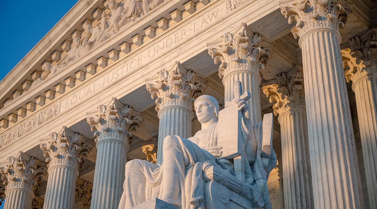 Exterior of Supreme Court of the United States on First Street in Washington DC, USA with statue by James Earle Fraser titled Authority of Law (1935)