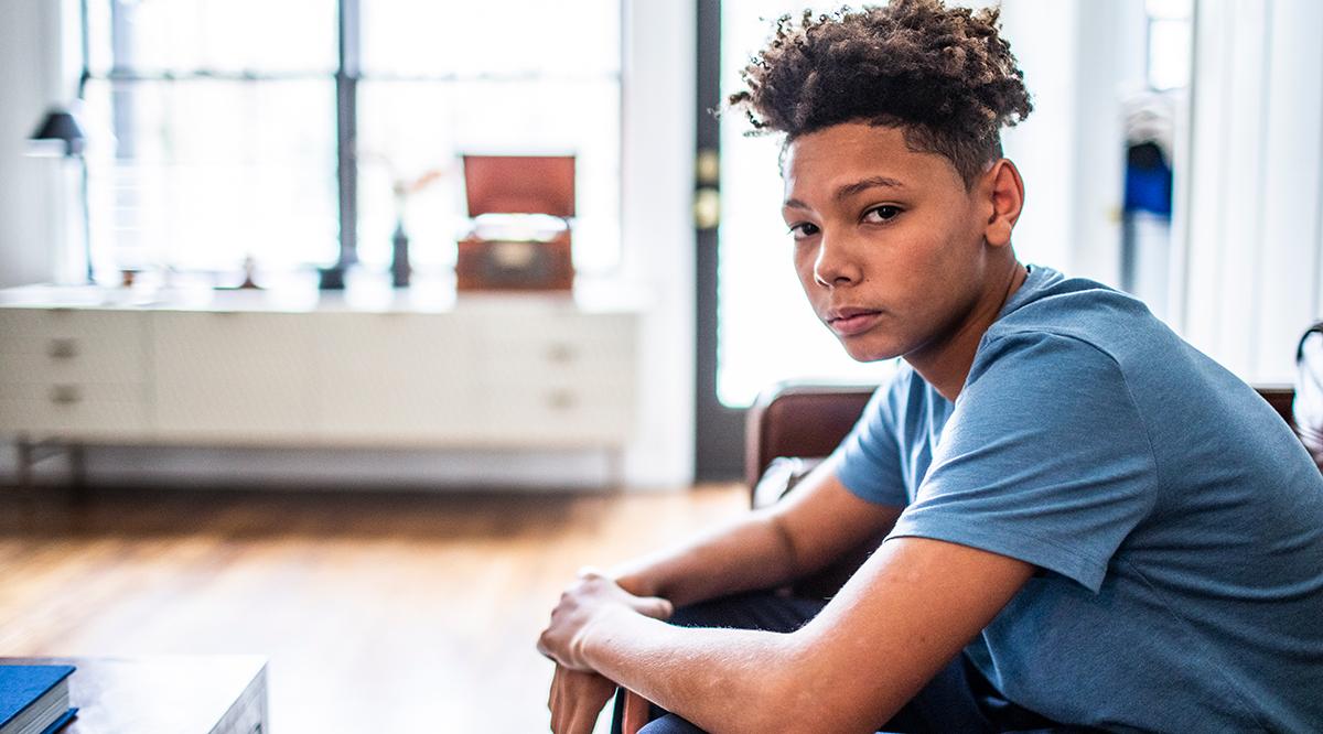 Teenage boy in residential living room